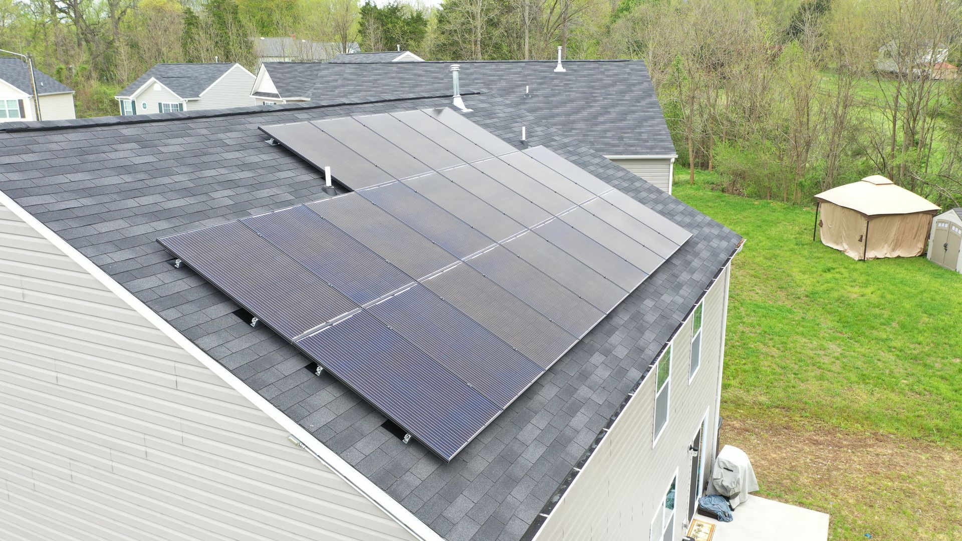 A house with a lot of solar panels on the roof.