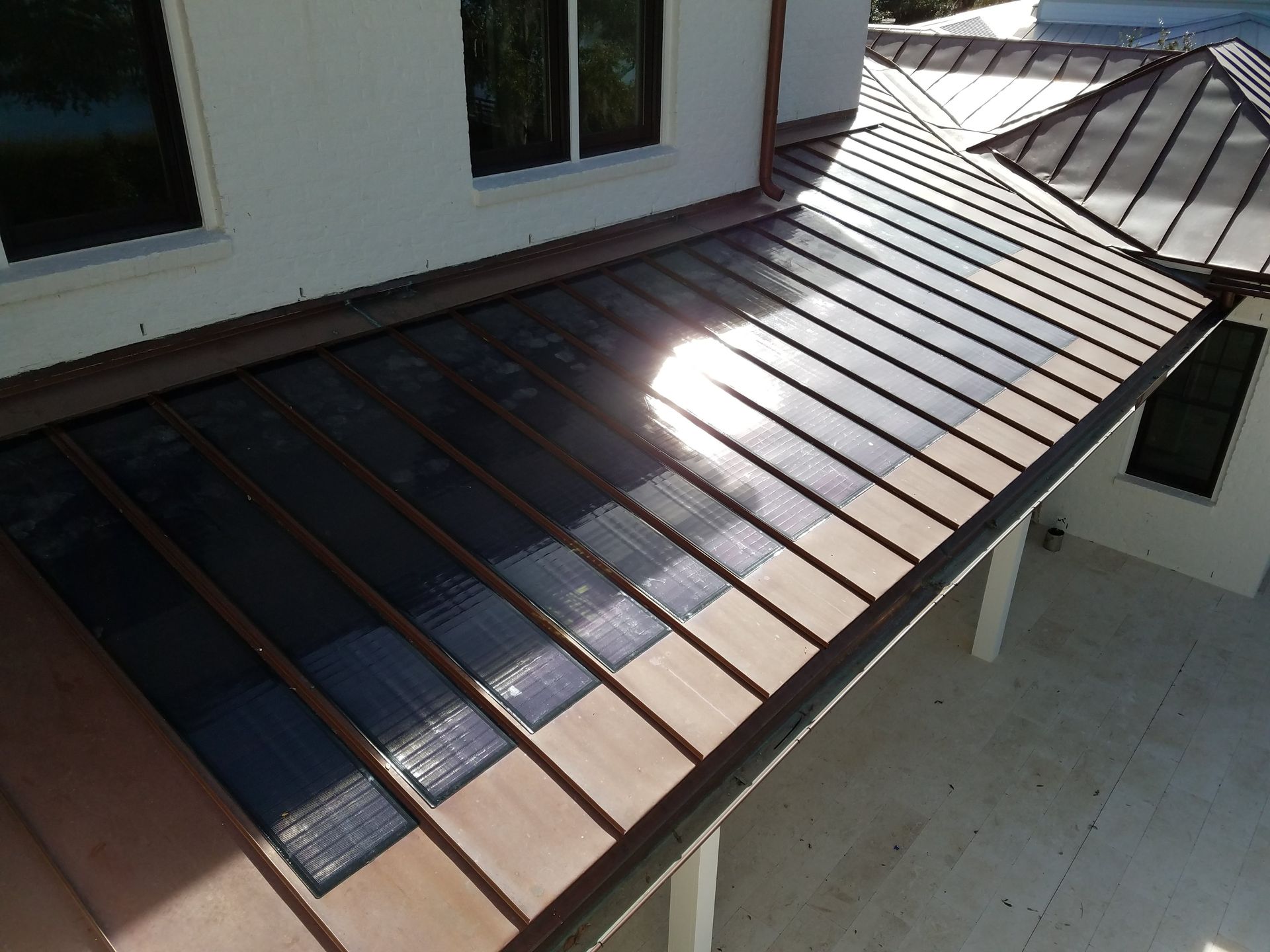 An aerial view of a house with a copper roof