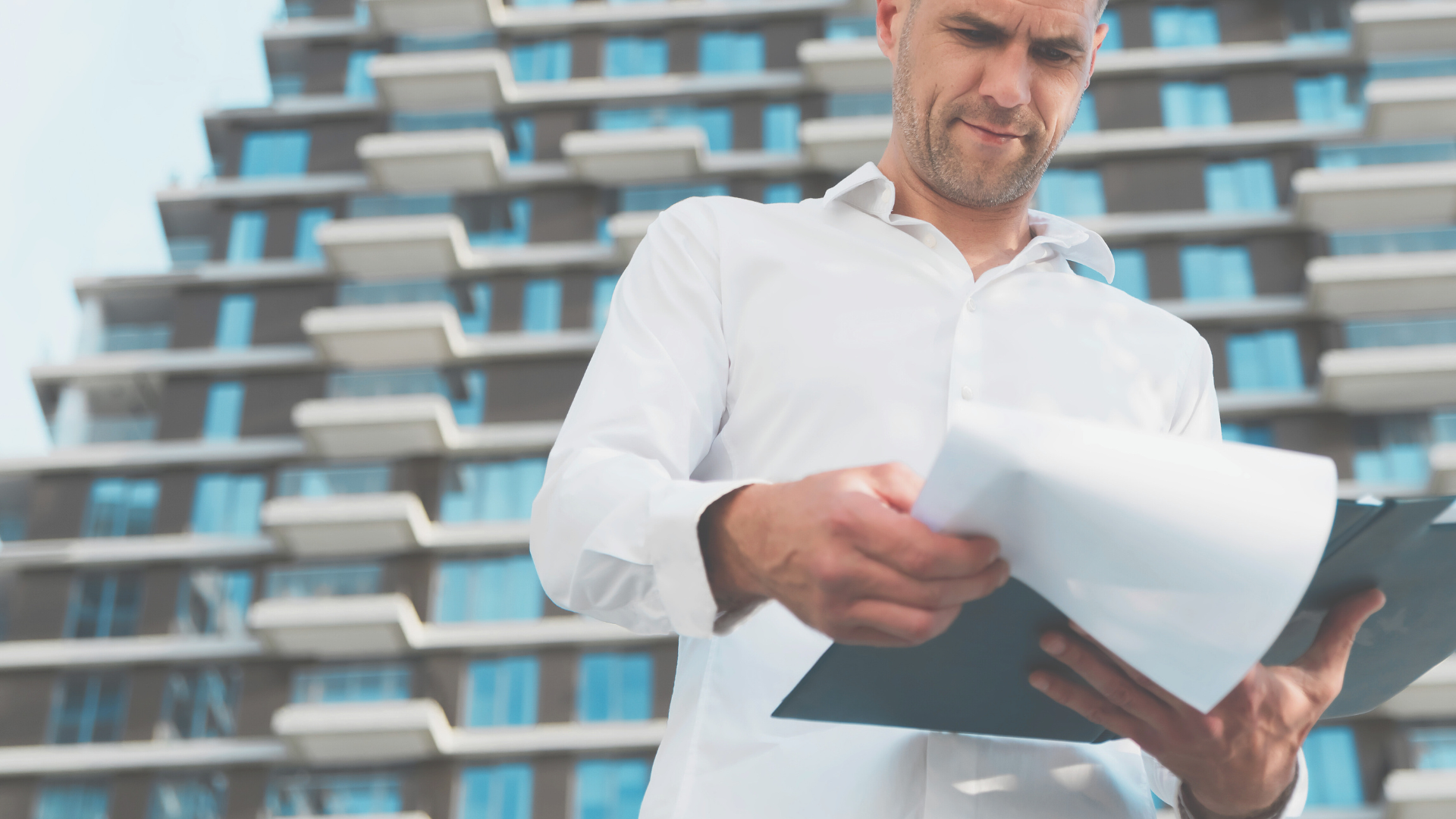 A construction business owner reviewing a staff's contract