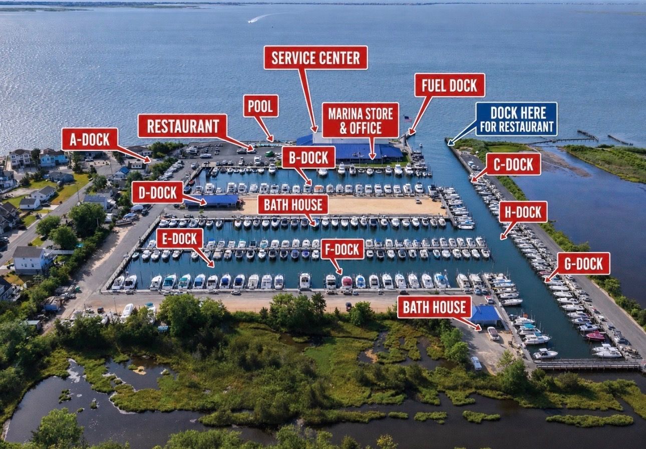 Aerial view of a marina with labeled docks, shops, parking lots, and a restaurant by the water