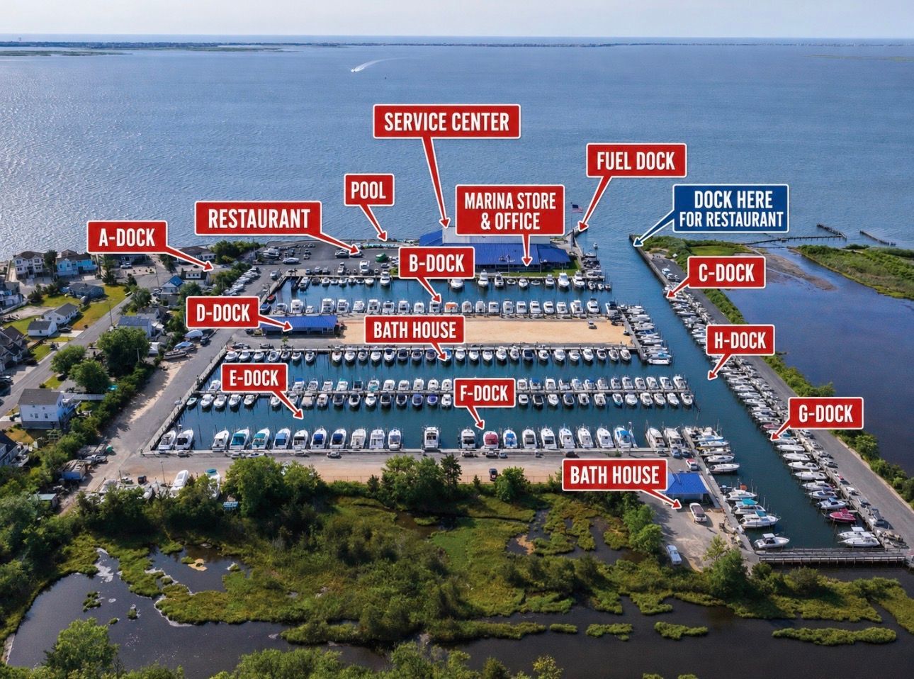 Aerial view of a marina with labeled docks, restaurant, fuel dock, and service center by the water