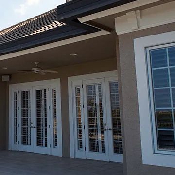 A house with a lot of windows and sliding glass doors.