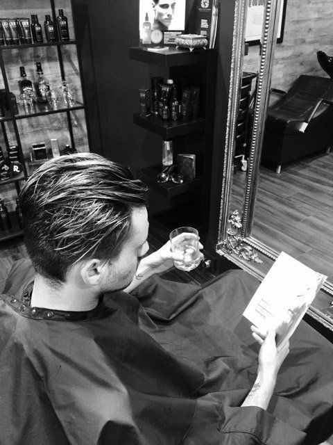man sitting in salon chair
