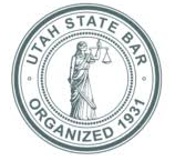 The seal of the utah state bar is a statue of justice holding a scale of justice.