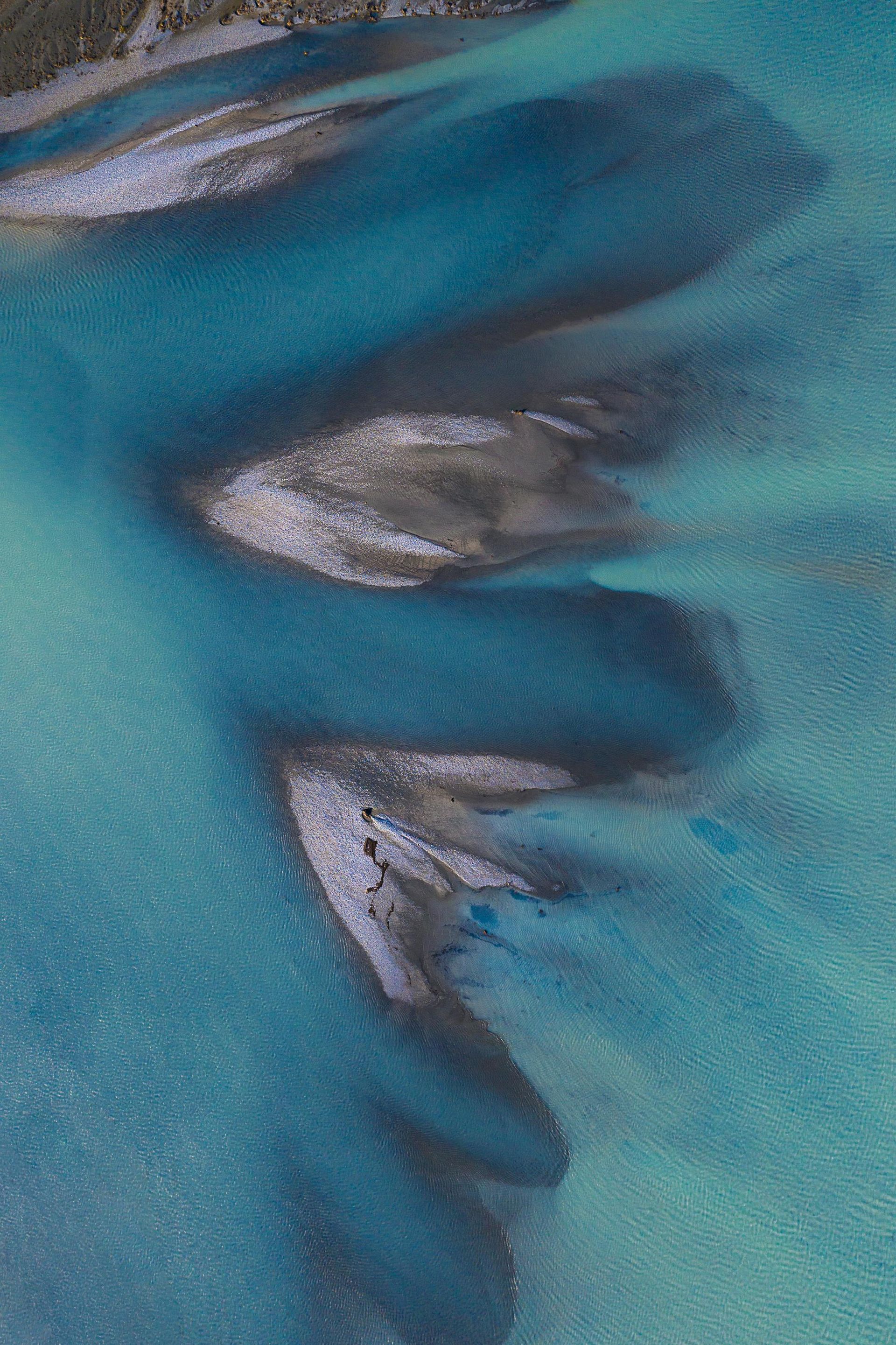An aerial view of a river flowing through a body of water.