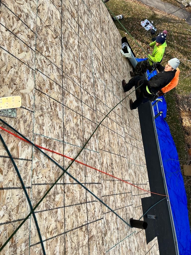 A group of people are working on a roof.