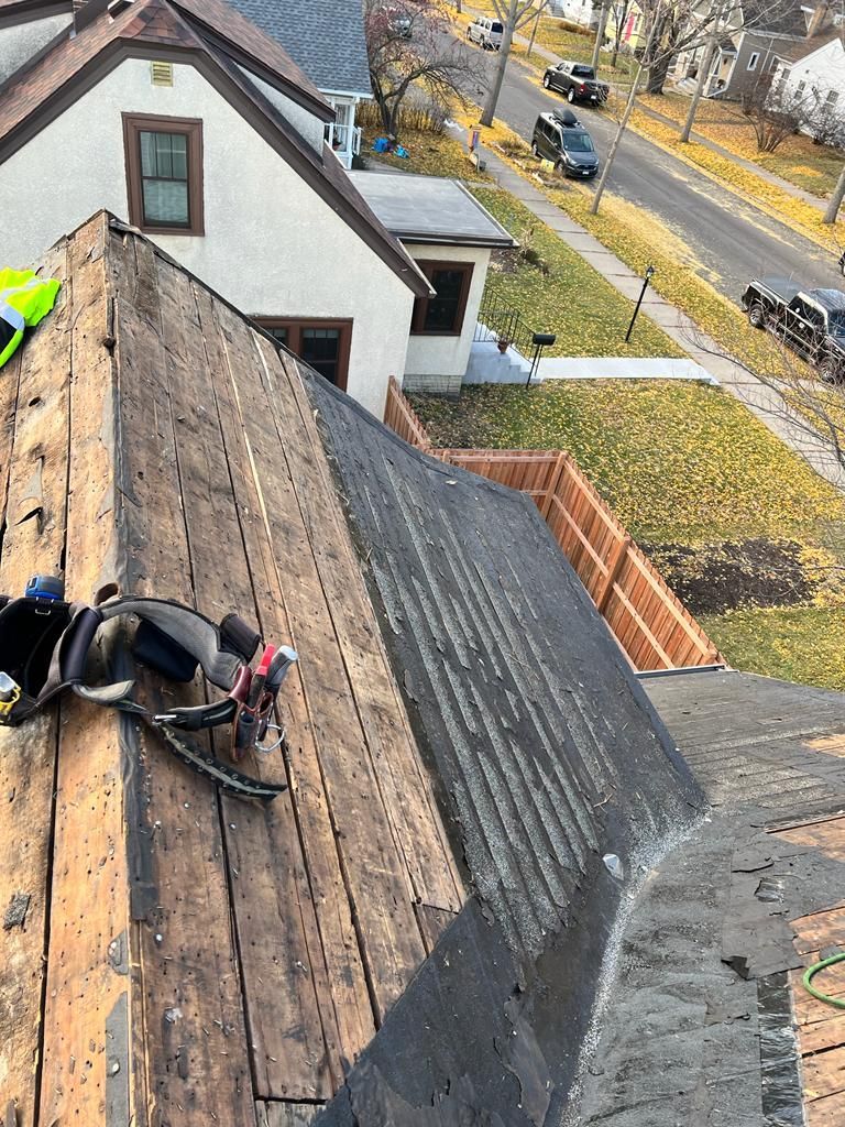 A person is working on the roof of a house.