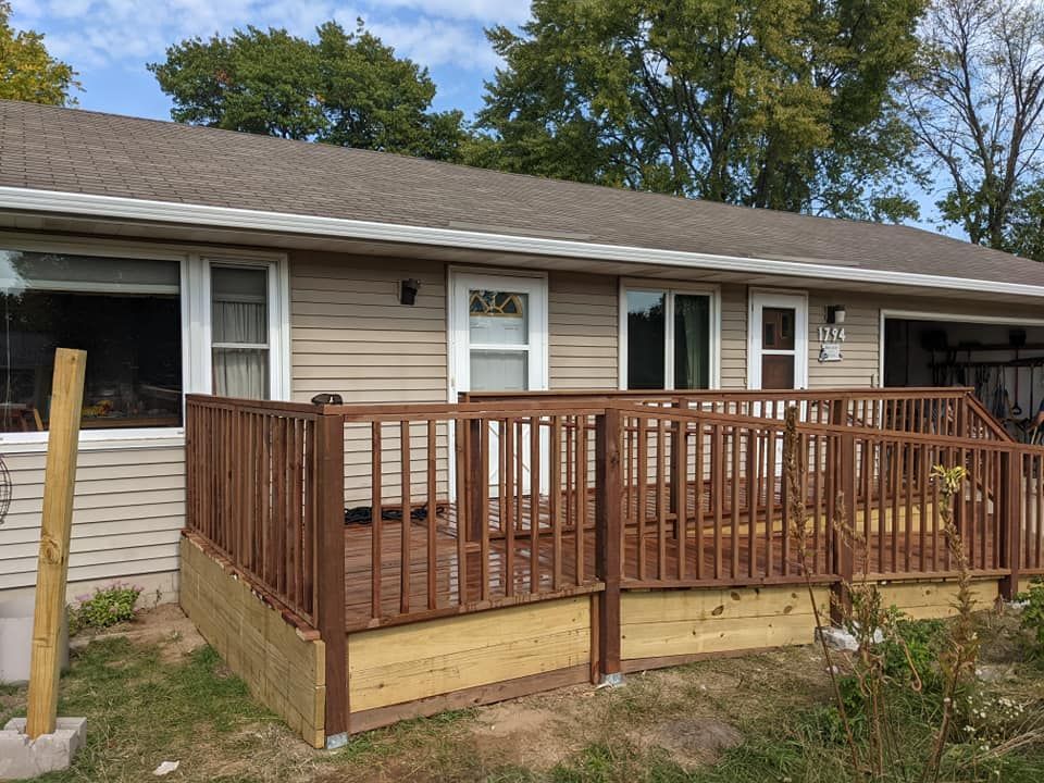 A house with a wooden deck in front of it