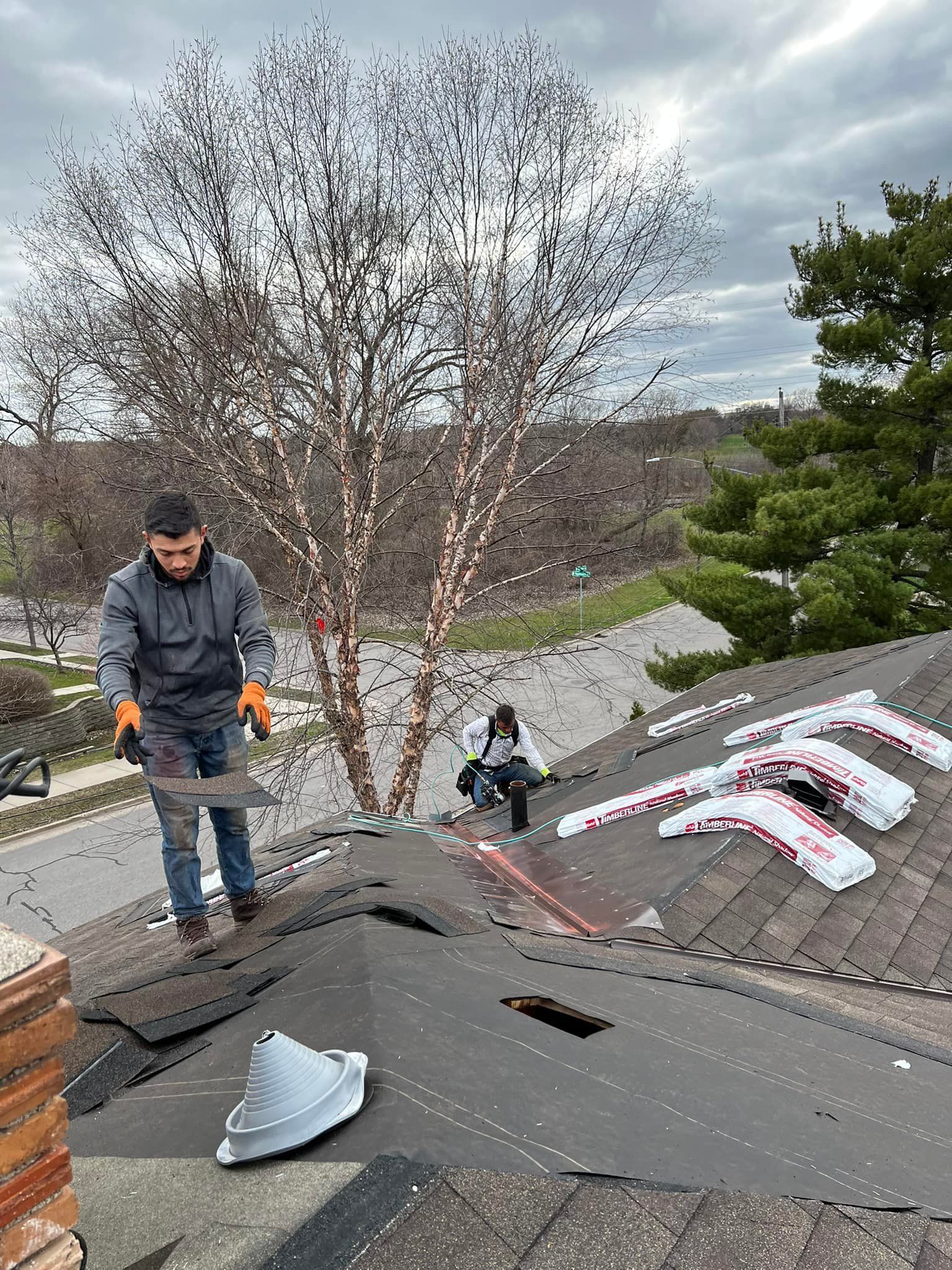 A man is working on the roof of a house.