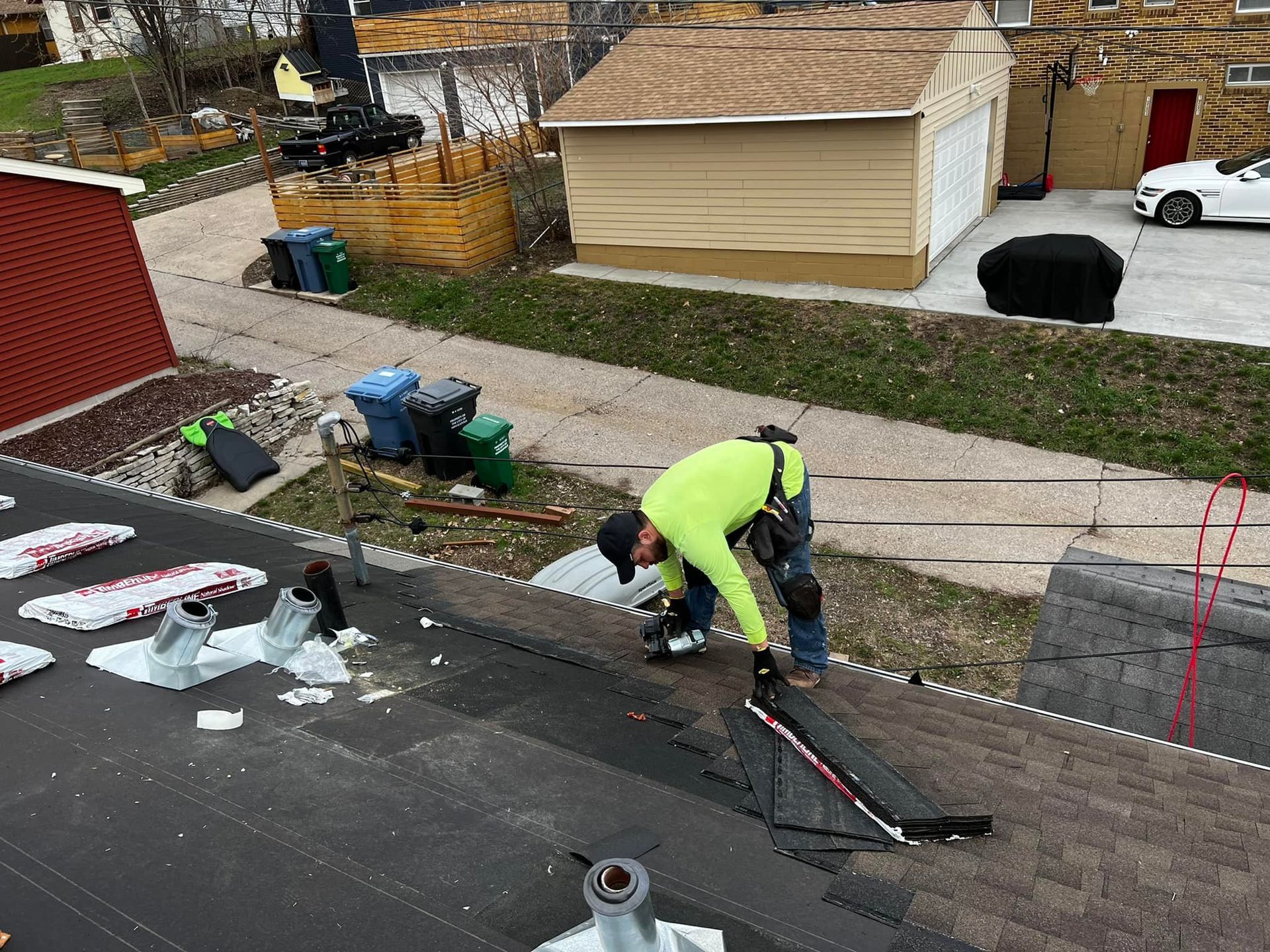 A man is working on the roof of a house.