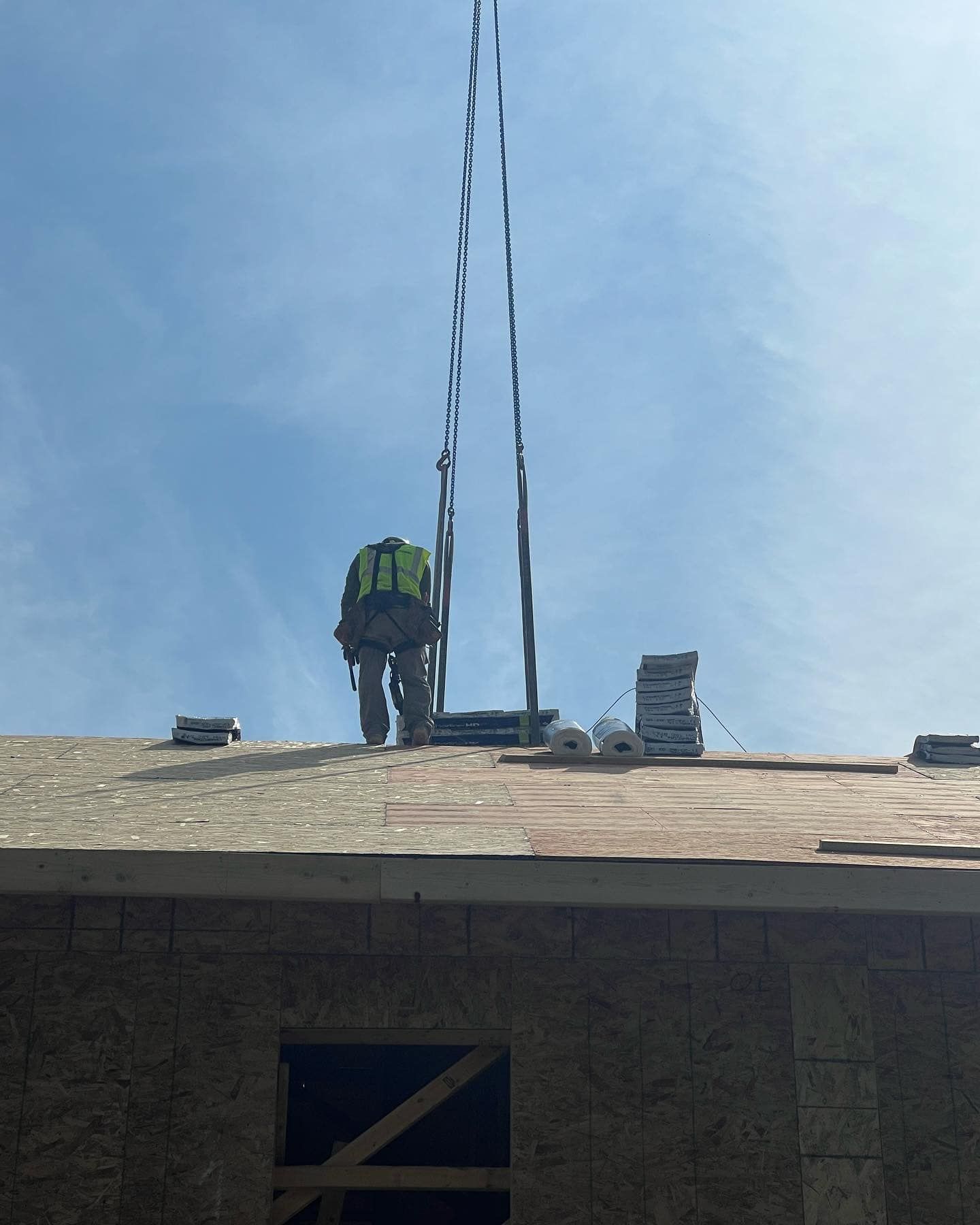 A man is working on the roof of a building