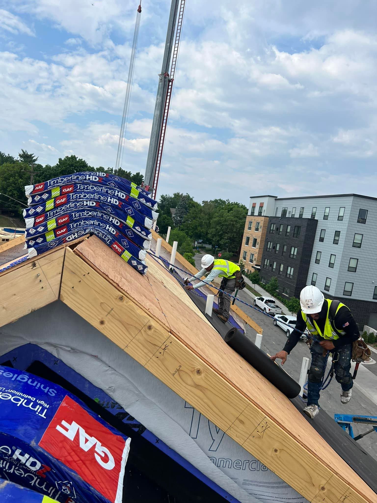 A group of construction workers are working on a roof.