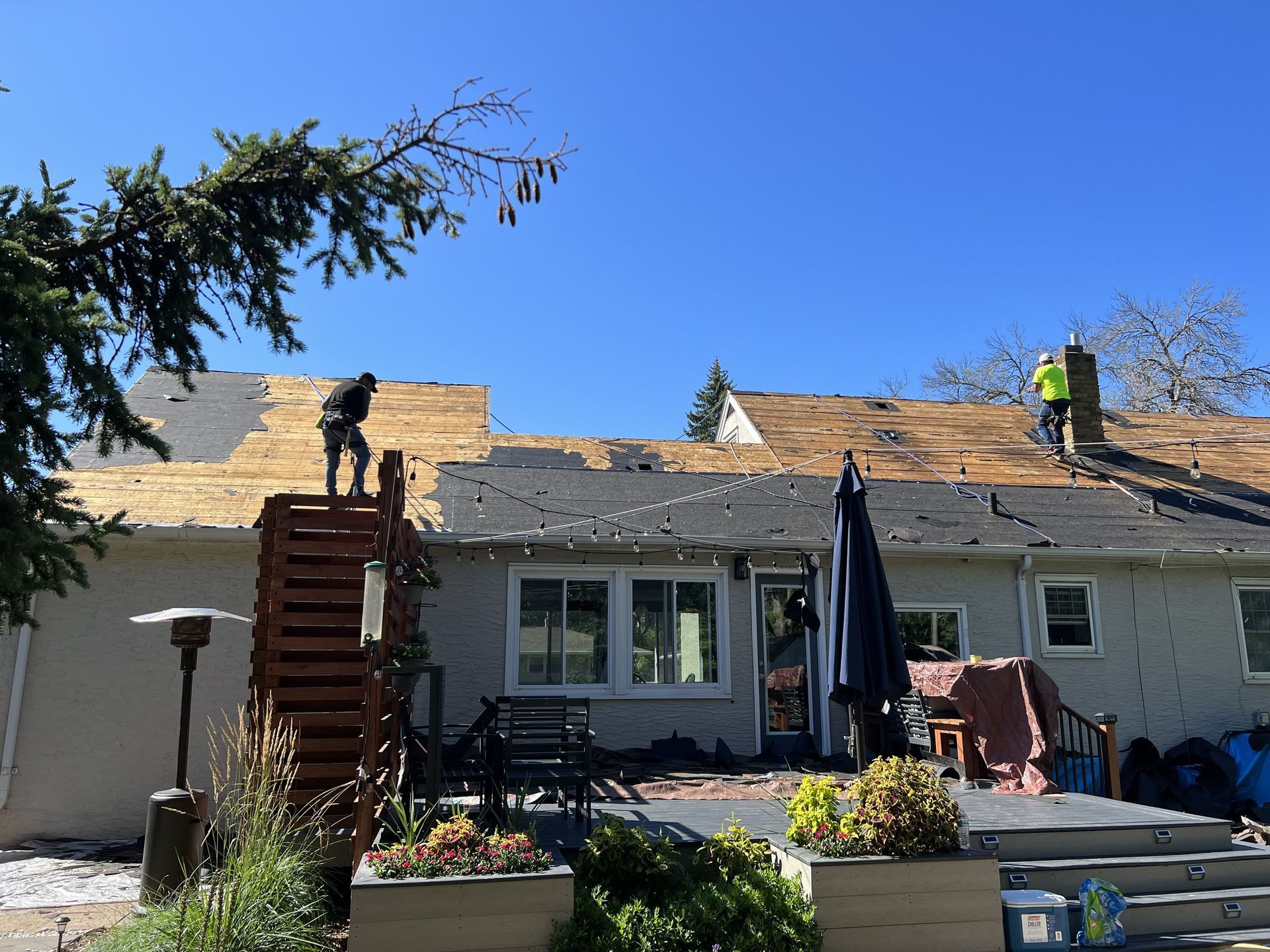 A man is working on the roof of a house