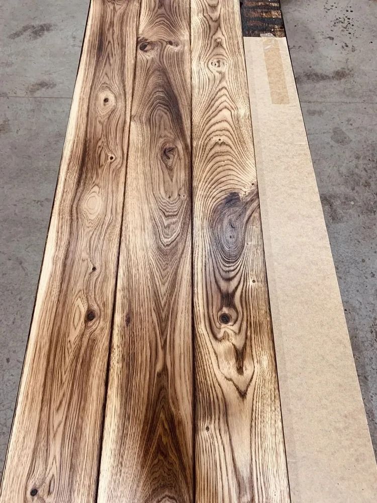 Three narrow wood planks with rustic grain on a work surface