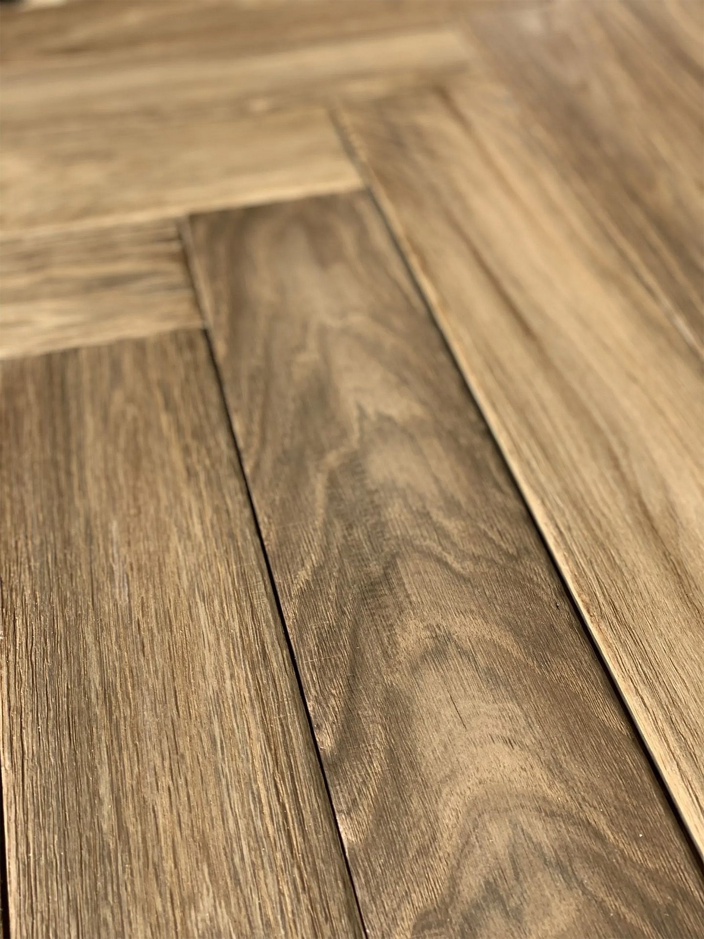 Close-up of warm-toned wooden floorboards with visible grain and seams