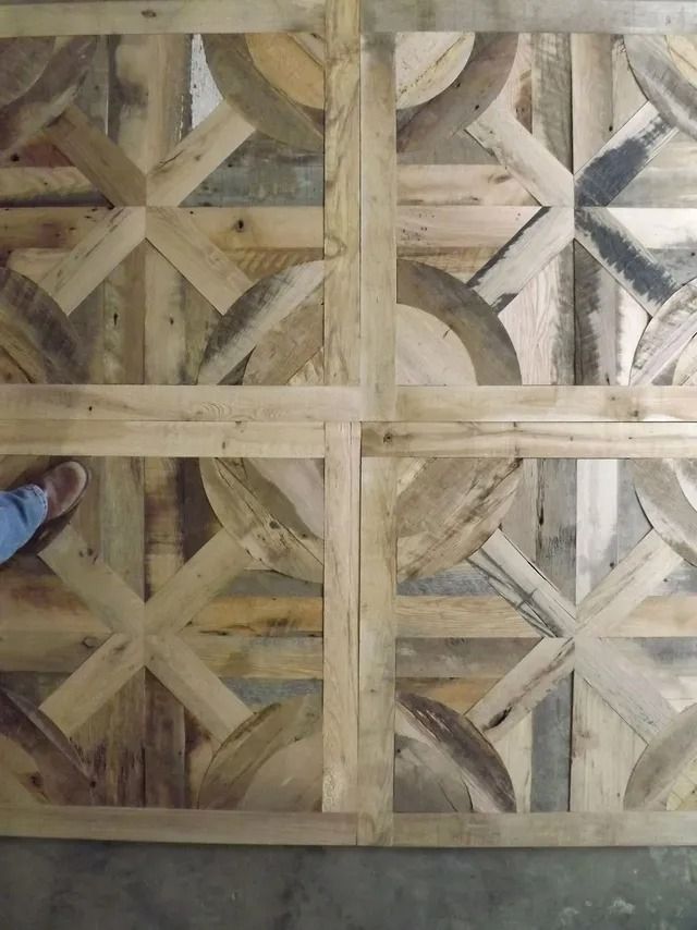 Wooden lattice panel with geometric star patterns in light and dark wood tones