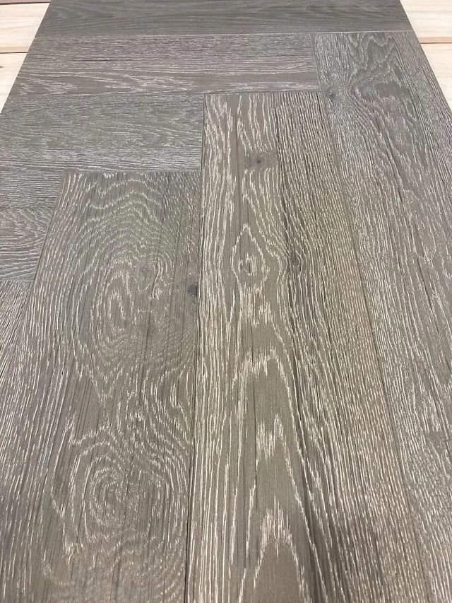 Wood-patterned gray floor tiles arranged in a staggered plank pattern.