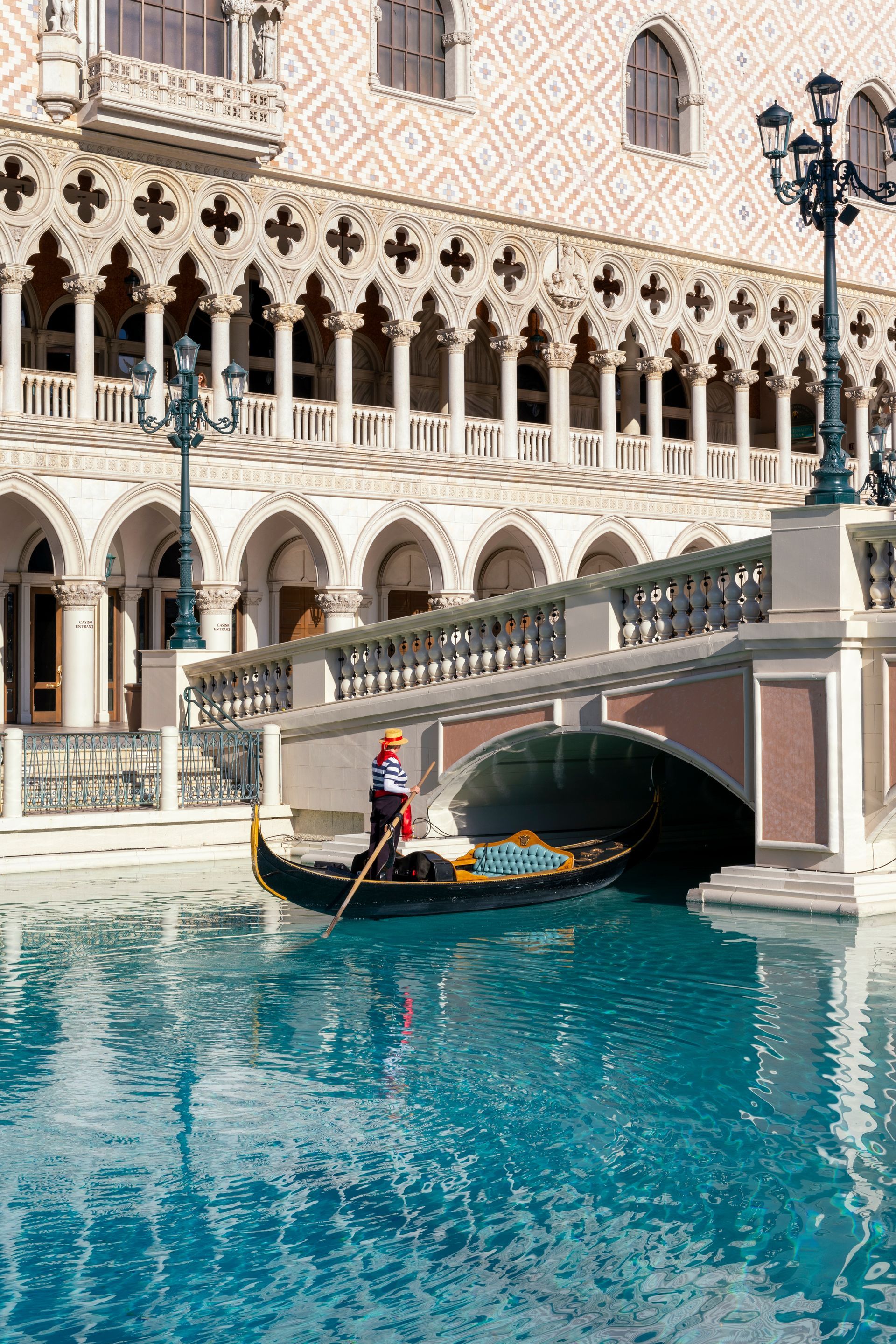 View of Siena, Italy, with striped bell tower, domed cathedral, and terracotta rooftops under cloudy sky.