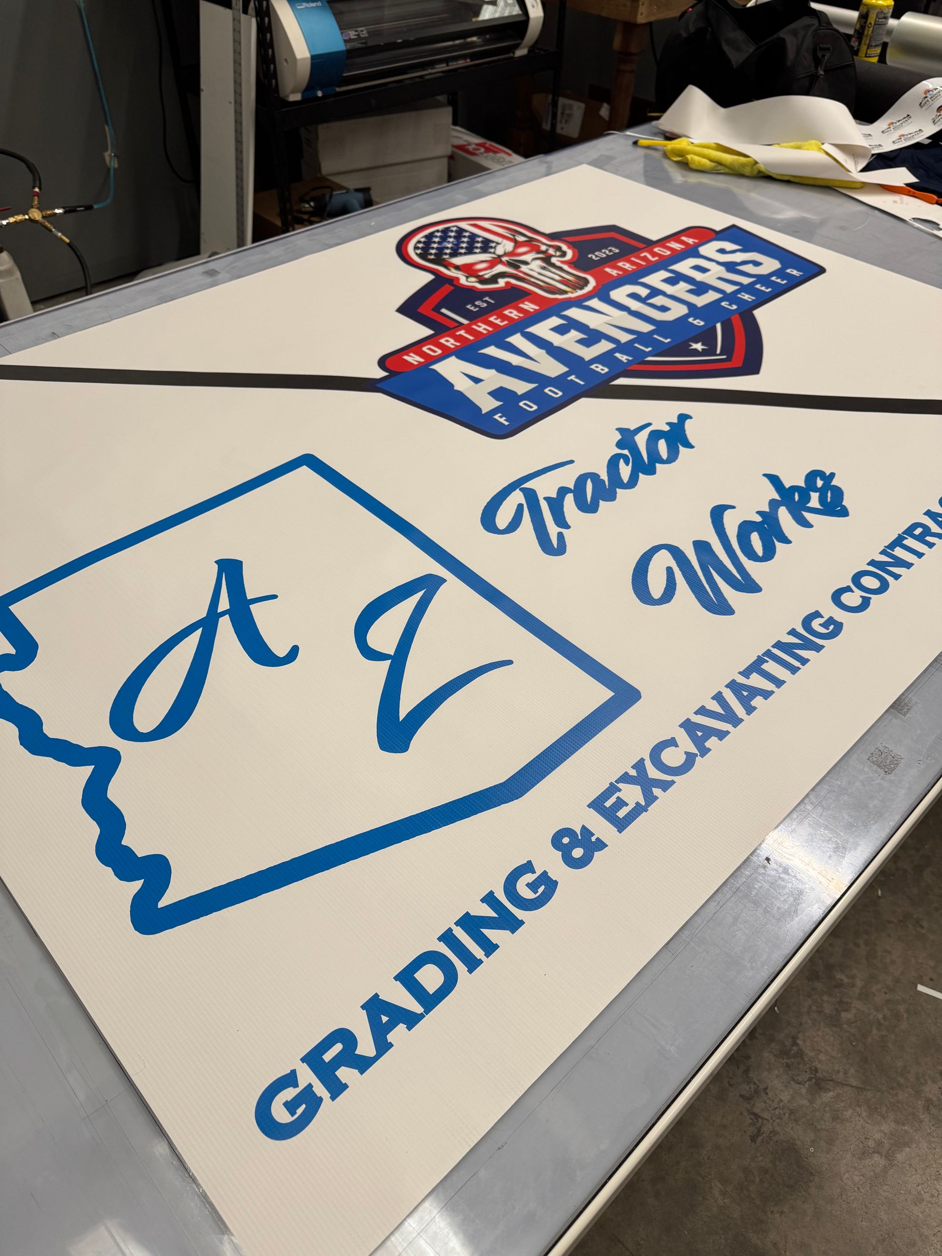 White sign with blue text: