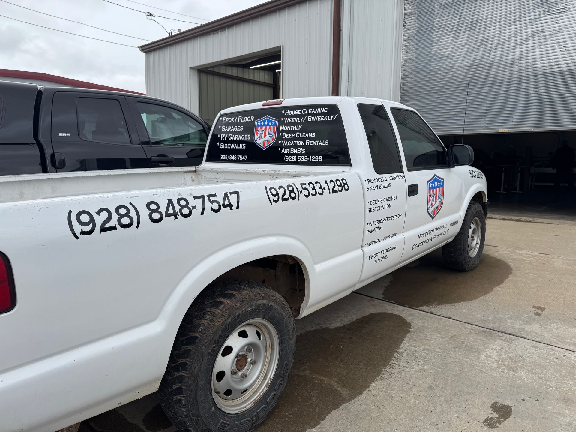 White pickup truck with business name and phone numbers (928) 848-7547 and (928) 533-7256. Parked outdoors.