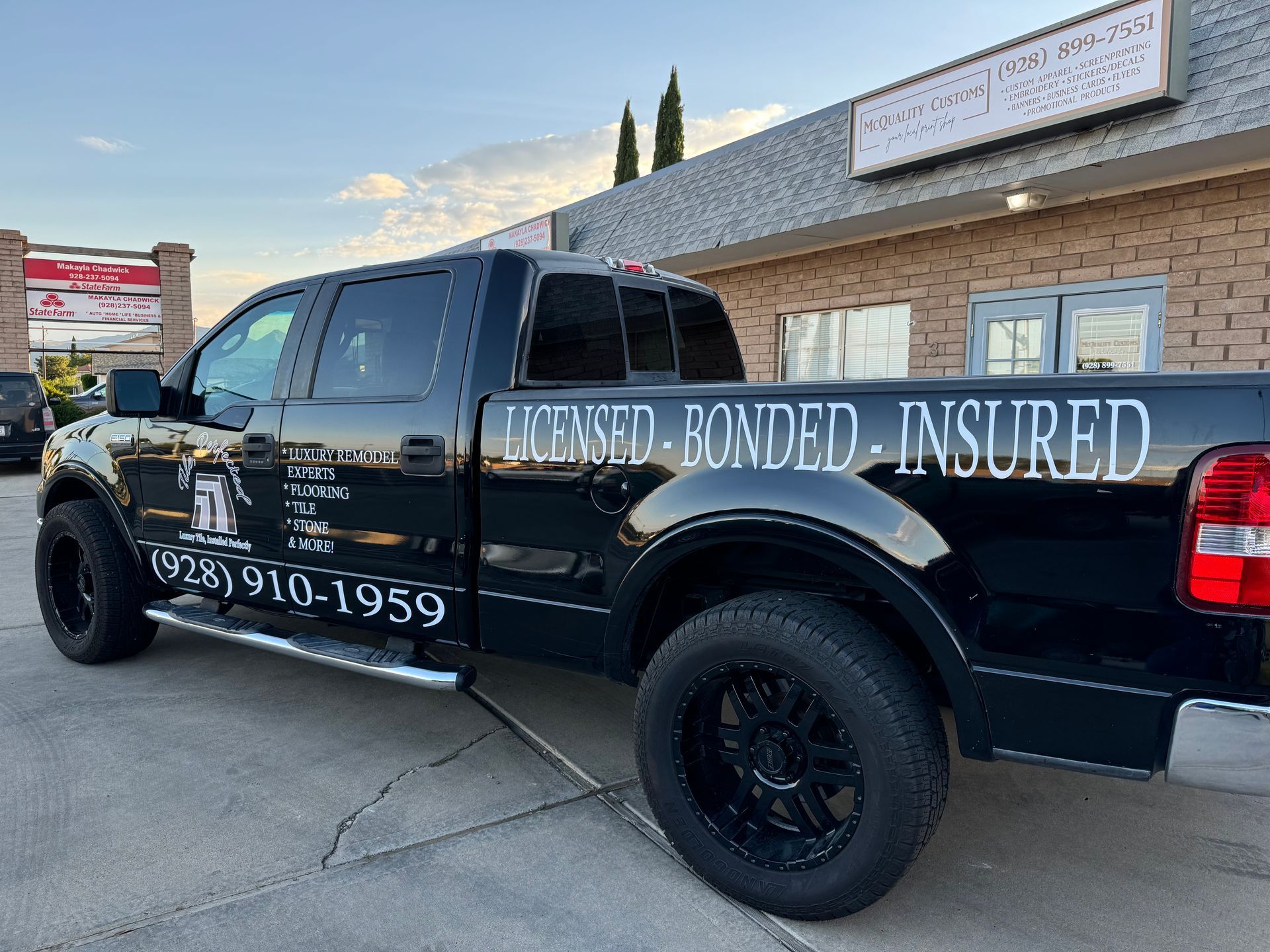 Black pickup truck with company logo and 