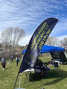 Arizona Modern Landscapes, LLC banner at outdoor event; green grass, blue sky.