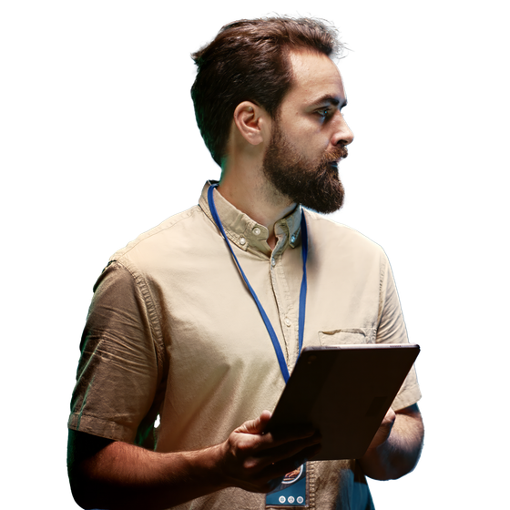 A man with a beard is holding a tablet computer.