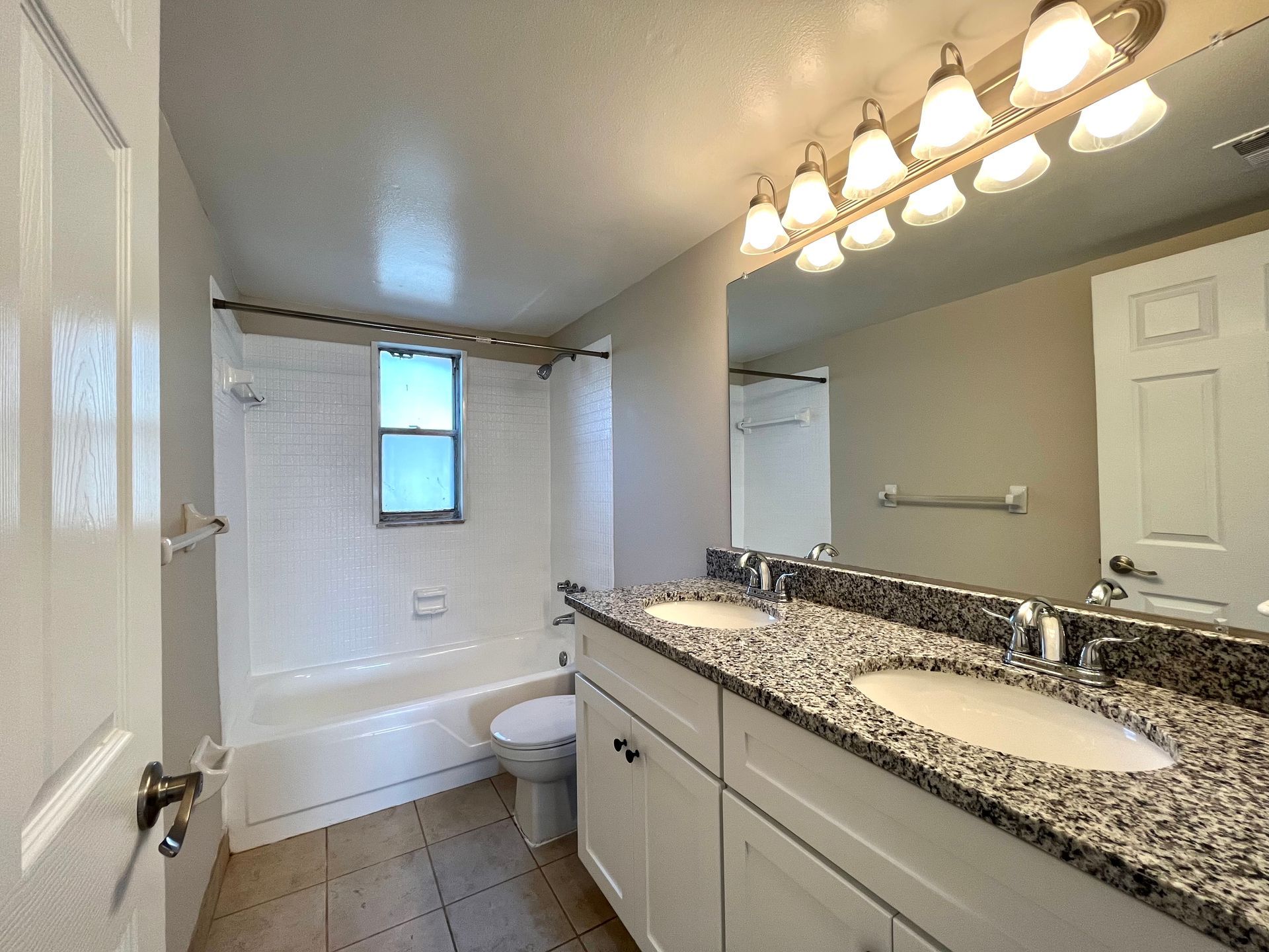 Bedroom with hardwood floor, closet, and ceiling fan.