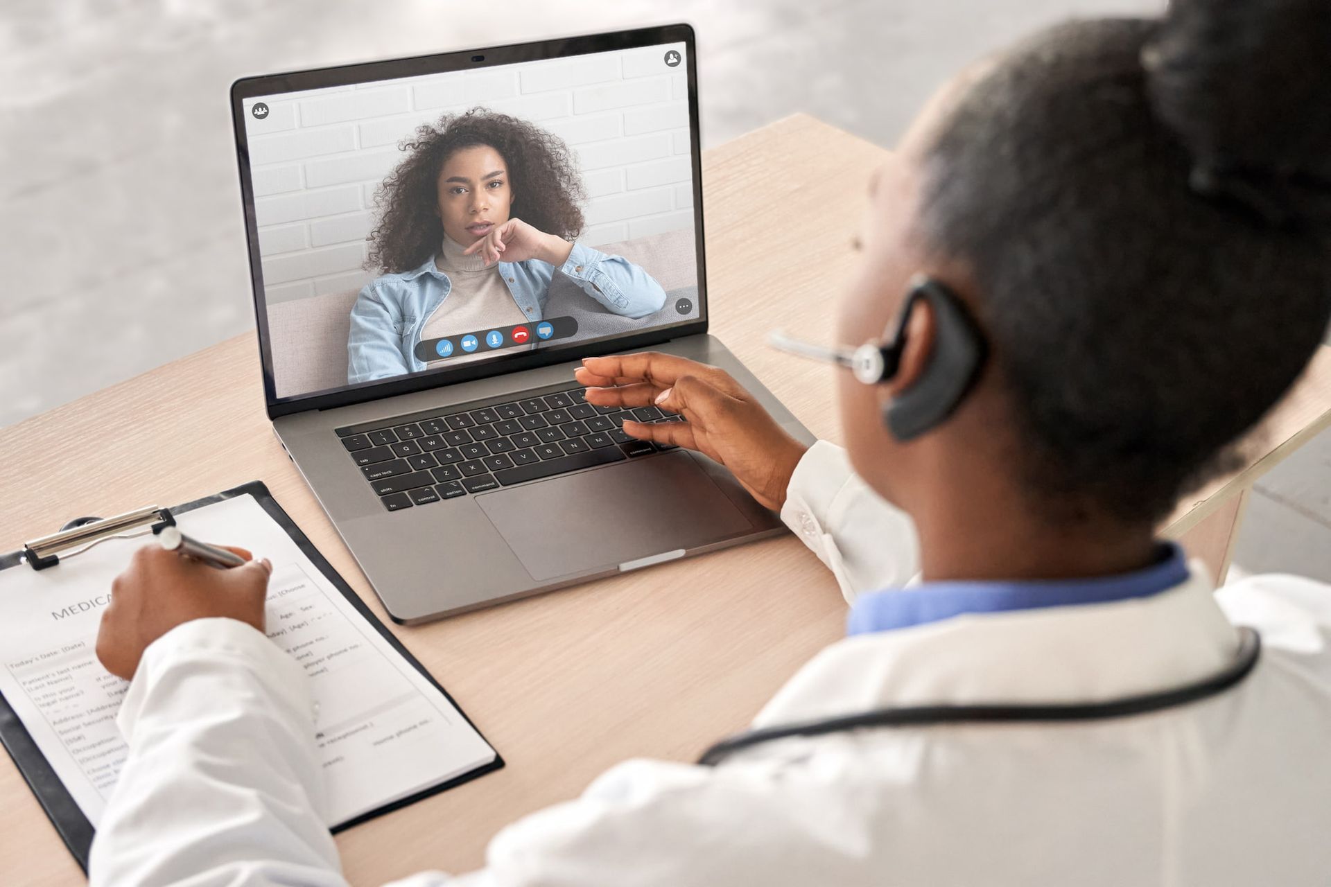 A woman wearing a headset is having a video call on her laptop. — Psych Solutions NT in Leanyer, NT