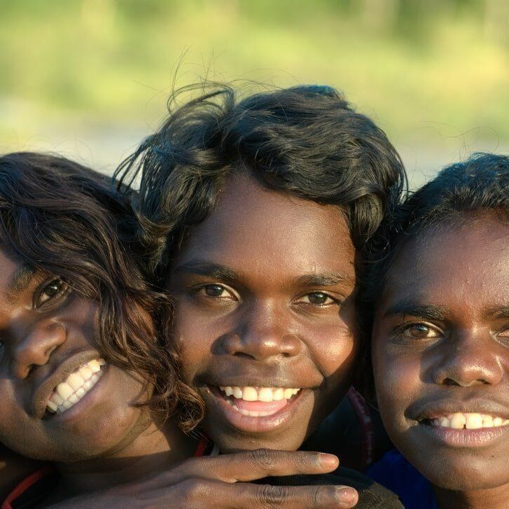 Three Young Girls Are Posing for A Picture and Smiling for The Camera — Psych Solutions NT in Katherine, NT