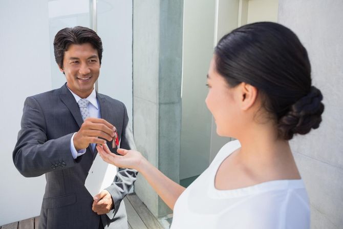 man handling the key to the woman