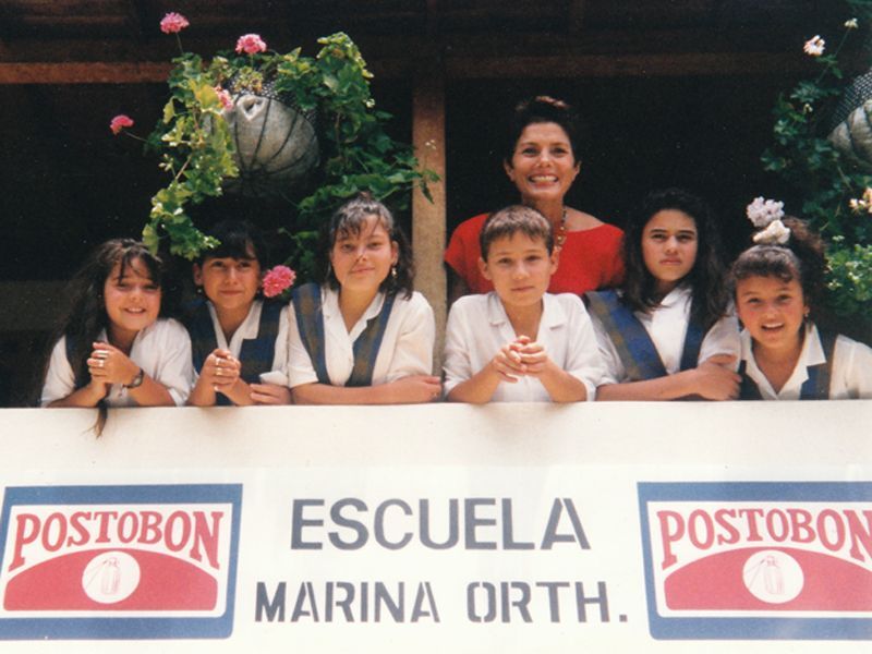 An image of Maureen Orth with students at the school she helped build in Colombia