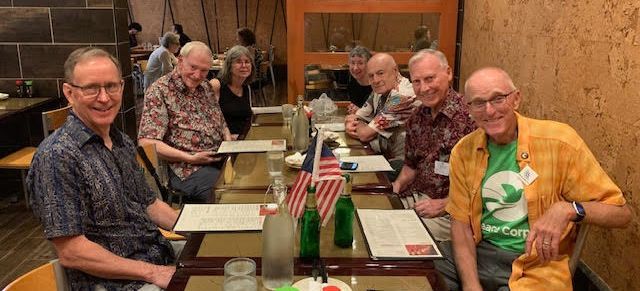 Members of Friends of Malaysia seated around a table at a restaurant.