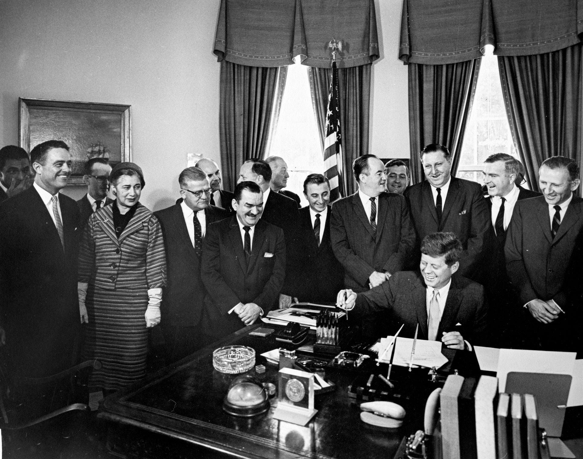 President John F. Kennedy signs the Peace Corps Act in the Oval Office on September 22, 1961