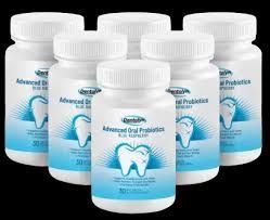 Bottles of dental probiotics next to a hand holding a tooth model. Text: 