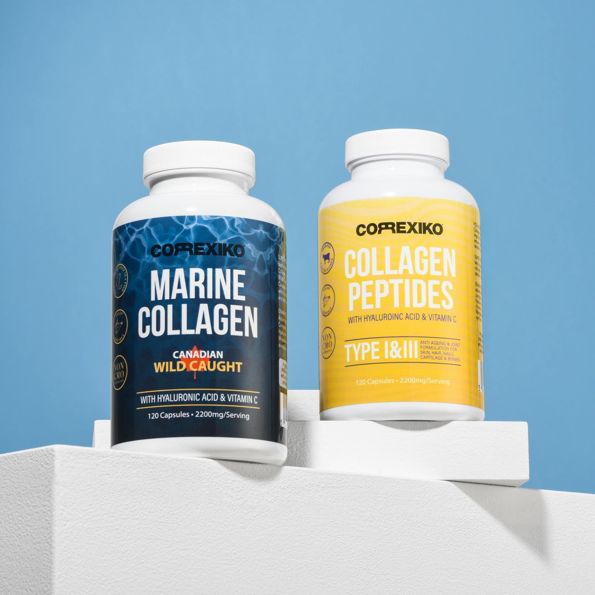 Two supplement bottles: marine collagen and collagen peptides, on a white block against a blue backdrop.