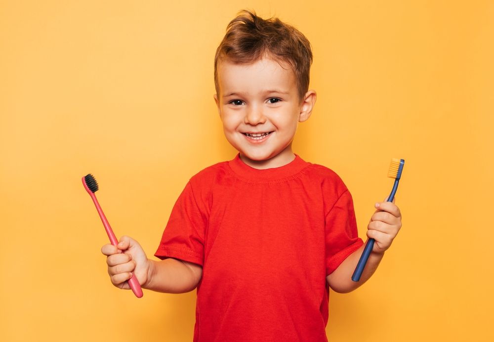 Boy holding a toothbrush