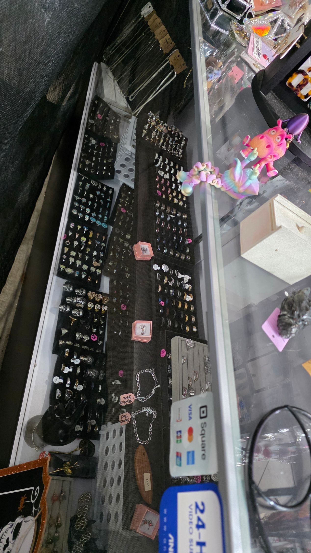 Jewelry display with earrings, bracelets, and other accessories in a store setting.