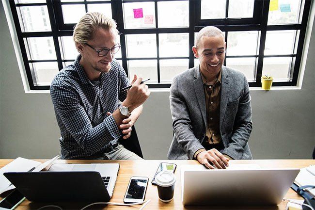 Two Men Using a Laptop Together in Office — Eatontown, NJ — Executive Suites at 12 Christopher Way