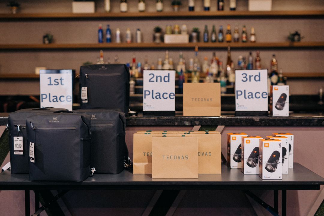 A table with boxes and bags on it and signs that say first place , second place , and third place.
