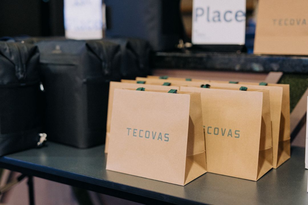 A stack of brown tecovas bags on a table