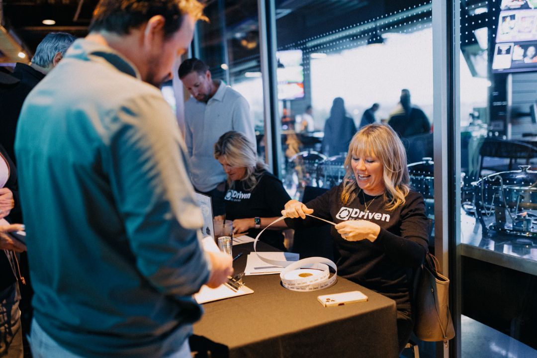 A woman is sitting at a table talking to a man.