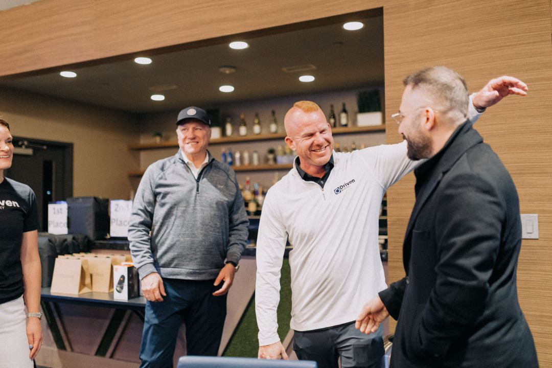 A group of men are standing next to each other in a room.