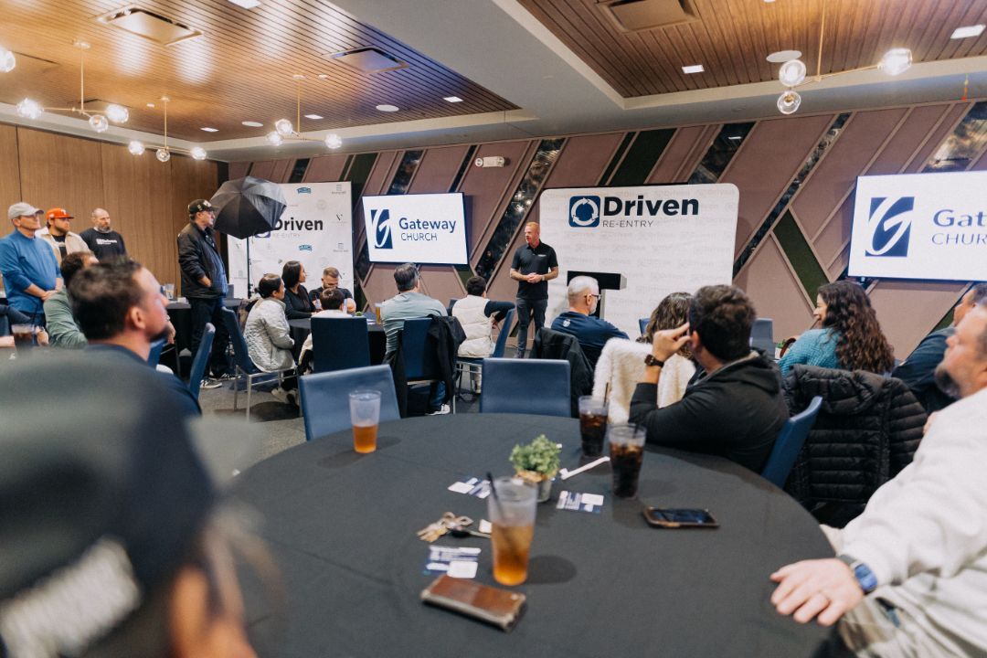 A group of people are sitting at tables in a room.
