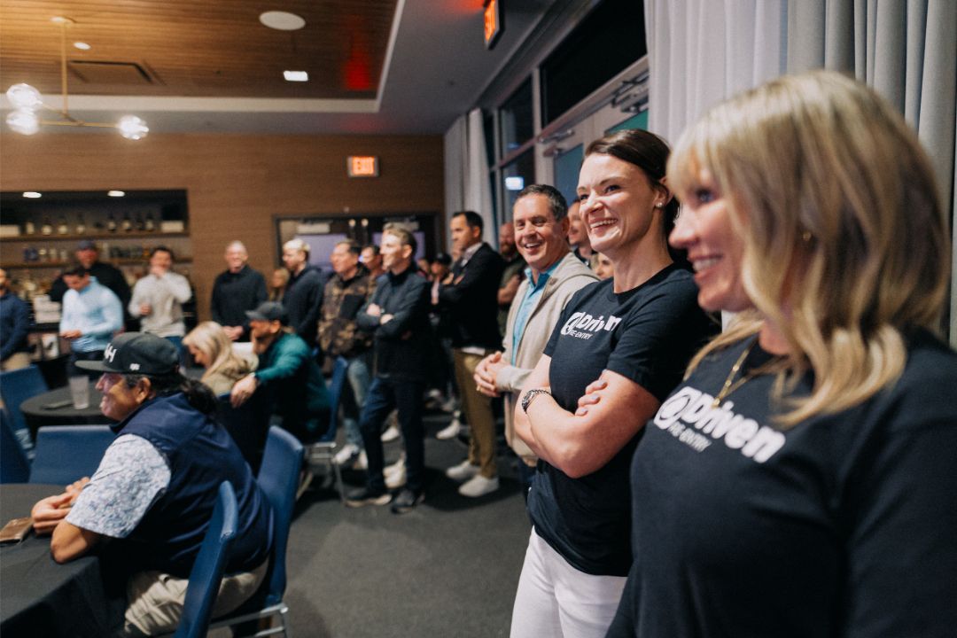 A group of people are standing in a room.