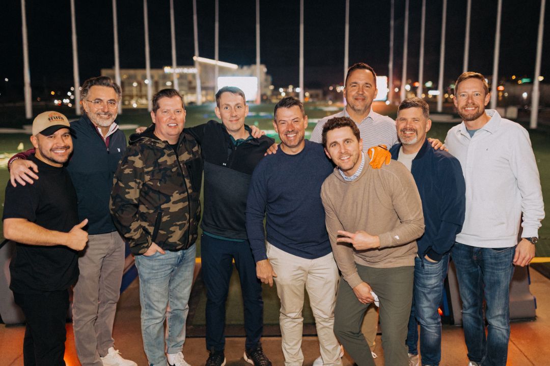 A group of men are posing for a picture together.