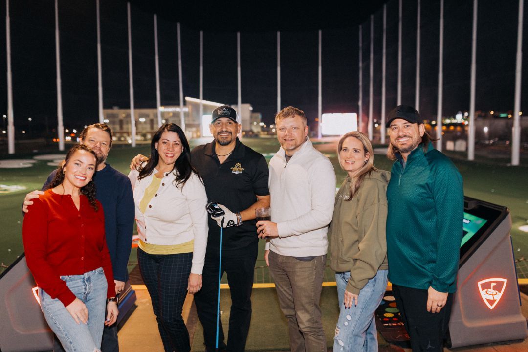 A group of people are standing next to each other on a golf course.
