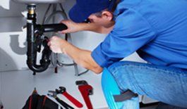 a plumber repairing a pipe