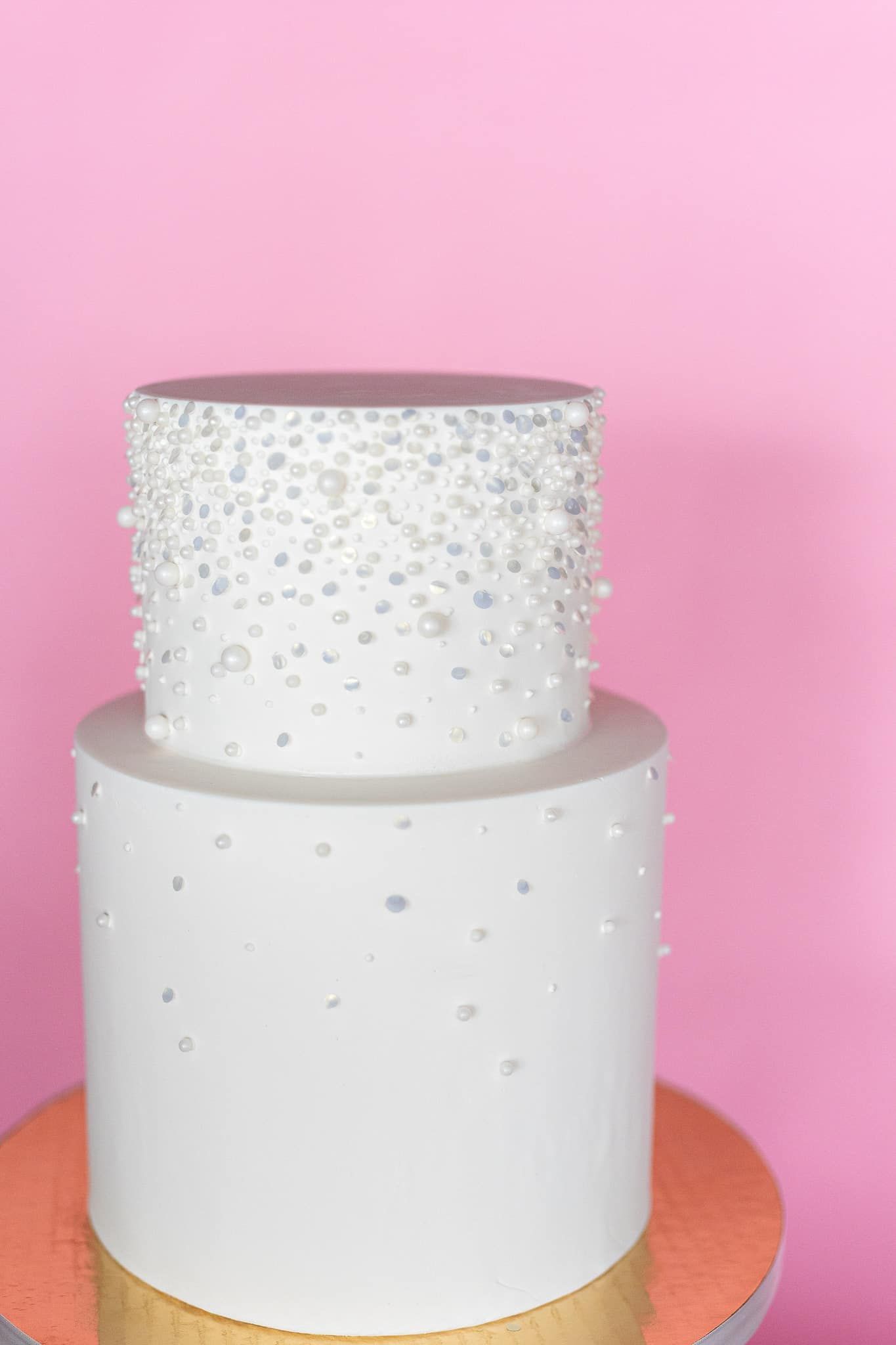 A woman in a white dress is holding a bouquet of flowers.