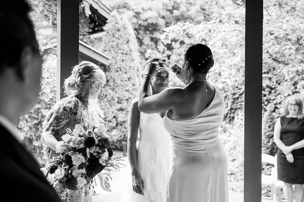 A black and white photo of a bride getting ready for her wedding ceremony.